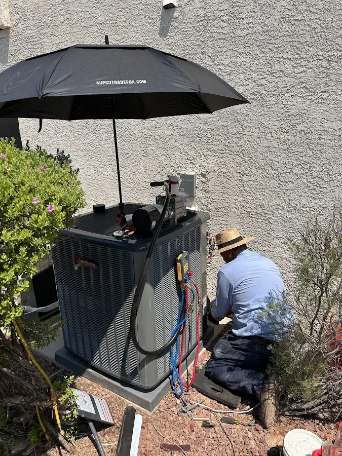 HVAC technician performing outdoor AC maintenance in Columbia